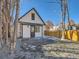 Back exterior showcasing a small white home with gray accents at 3120 N Race St, Denver, CO 80205