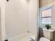 Clean bathroom with white subway tiles, bathtub, and toilet at 3120 N Race St, Denver, CO 80205