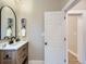 Modern bathroom with light wood vanity and arched mirror at 3120 N Race St, Denver, CO 80205