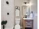 Bright bathroom with tiled shower, modern vanity, and decorative accents at 3120 N Race St, Denver, CO 80205