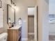 Well-lit bathroom features a modern vanity, patterned tile floor, and storage closet at 3120 N Race St, Denver, CO 80205