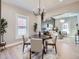 Elegant dining room with a dark wood table, neutral chairs, and a stylish chandelier at 3120 N Race St, Denver, CO 80205