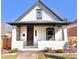 Charming bungalow with white brick and unique scale siding detail under the eaves at 3120 N Race St, Denver, CO 80205