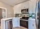 Modern kitchen features stainless steel appliances, including a dishwasher, oven, and microwave at 3120 N Race St, Denver, CO 80205