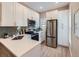 Modern kitchen with white cabinets, stainless steel appliances, and a quartz countertop at 3120 N Race St, Denver, CO 80205