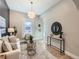 Light-filled living room with a stylish sofa, accent chair, and a unique wall accent at 3120 N Race St, Denver, CO 80205