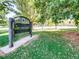 Park entrance sign surrounded by a lush green lawn and mature trees, creating a serene atmosphere at 3120 N Race St, Denver, CO 80205