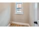 Small room with a window, neutral walls, and light wood flooring at 3120 N Race St, Denver, CO 80205