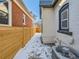 Side yard with wooden fence and snow at 3120 N Race St, Denver, CO 80205