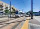 Modern train at station with overhead power lines, a yellow safety strip, and a backdrop of residential building at 3120 N Race St, Denver, CO 80205