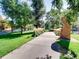 Paved walkway winds through a park with lush greenery and a musical sculpture at 3120 N Race St, Denver, CO 80205