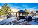 Inviting backyard with a gazebo, seating area, and snow-covered lawn at 24191 E Iowa Pl, Aurora, CO 80018