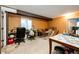 Unfinished basement room featuring windows, beams, furniture, and neutral walls at 24191 E Iowa Pl, Aurora, CO 80018