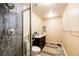 Bathroom featuring marble tile shower, dark vanity with marble countertop, and sleek shower head at 24191 E Iowa Pl, Aurora, CO 80018