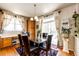 Cozy dining area with a glass-top table, comfortable seating, and a view of the outdoor patio at 24191 E Iowa Pl, Aurora, CO 80018