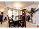 Elegant dining room with a large wooden table, chandelier lighting, and a decorative plant at 24191 E Iowa Pl, Aurora, CO 80018