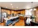 Bright and airy kitchen with wood cabinets, a breakfast bar, and modern appliances at 24191 E Iowa Pl, Aurora, CO 80018