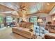 Finished basement features exposed wood ceiling, comfortable furniture, and a billiards table at 7800 Indiana St, Arvada, CO 80007