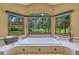 Bright bathroom featuring a large soaking tub with views of the surrounding scenery at 7800 Indiana St, Arvada, CO 80007