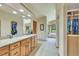 Bright bathroom with granite counters, modern fixtures, soaking tub and access to large closet at 7800 Indiana St, Arvada, CO 80007