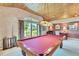 Recreational room with a billiard table, wood ceiling, and carpeted floor at 7800 Indiana St, Arvada, CO 80007