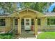 Inviting brick front porch with decorative accents and a charming entrance door at 7800 Indiana St, Arvada, CO 80007