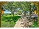 Scenic view of the lush front yard from the front porch, showcasing mature trees at 7800 Indiana St, Arvada, CO 80007