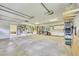 Expansive garage featuring a work area, tool storage, and plenty of open space for vehicles at 7800 Indiana St, Arvada, CO 80007
