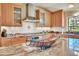 Granite kitchen island with a decorative fruit basket and pendant lighting at 7800 Indiana St, Arvada, CO 80007