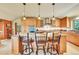 Well-appointed kitchen featuring granite countertops, custom cabinets, and stainless steel appliances at 7800 Indiana St, Arvada, CO 80007