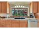 Kitchen sink and countertop with a large window providing natural light and outdoor views at 7800 Indiana St, Arvada, CO 80007