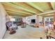 Comfortable living room with beamed ceilings, plush seating, and an open layout at 7800 Indiana St, Arvada, CO 80007