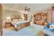 Large bedroom with a king bed, ceiling fan, and built-in bookcase at 7800 Indiana St, Arvada, CO 80007