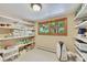 Well-organized pantry with shelving units and window, perfect for storing food and supplies at 7800 Indiana St, Arvada, CO 80007