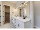 Double vanity bathroom with modern fixtures and a large mirror at 1881 Grayside Cir, Castle Rock, CO 80109