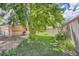 Backyard with an outdoor grill, patio, and a lush lawn featuring stone accents at 6991 Warren Dr, Denver, CO 80221