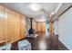 A spacious basement featuring wood-paneled walls and a vintage wood-burning stove at 6991 Warren Dr, Denver, CO 80221