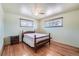 Bedroom featuring hardwood floors, a ceiling fan, and a wood-framed bed at 6991 Warren Dr, Denver, CO 80221