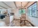 Charming dining area with a cozy rocking chair and natural light from two windows at 6991 Warren Dr, Denver, CO 80221