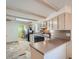 A kitchen featuring light-colored cabinets, black appliances, and a neutral countertop at 6991 Warren Dr, Denver, CO 80221