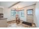 Dining area with updated lighting, cozy rocking chair, and neutral decor at 6991 Warren Dr, Denver, CO 80221