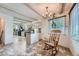 Inviting dining area with updated lighting, cozy rocking chair, and neutral decor at 6991 Warren Dr, Denver, CO 80221