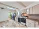 Bright kitchen featuring updated appliances, neutral cabinets, and convenient layout at 6991 Warren Dr, Denver, CO 80221