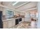 Bright kitchen featuring updated appliances, neutral cabinets, and open access at 6991 Warren Dr, Denver, CO 80221