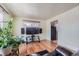 Bright living room with hardwood floors, large window, and entertainment center at 6991 Warren Dr, Denver, CO 80221