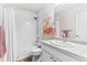 Cozy bathroom featuring a shower over tub, white cabinets, and stylish accessories at 4774 Kittredge St, Denver, CO 80239