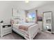 Bright bedroom with a patterned bedspread, light-colored walls, and comfortable decor at 4774 Kittredge St, Denver, CO 80239