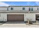 Attached garage with a brown garage door on this condo at 4774 Kittredge St, Denver, CO 80239