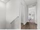 Well-lit hallway with wood floors leads to bedroom and bathroom, featuring neutral paint at 4774 Kittredge St, Denver, CO 80239