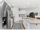 Bright kitchen featuring stainless steel appliances, a breakfast bar, and access to living areas at 4774 Kittredge St, Denver, CO 80239
